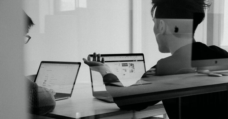 Men working computers building AI language models